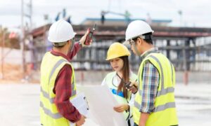 Construction team reviewing site plans and elevations during a project in Kansas City, highlighting the importance of topographic surveys.